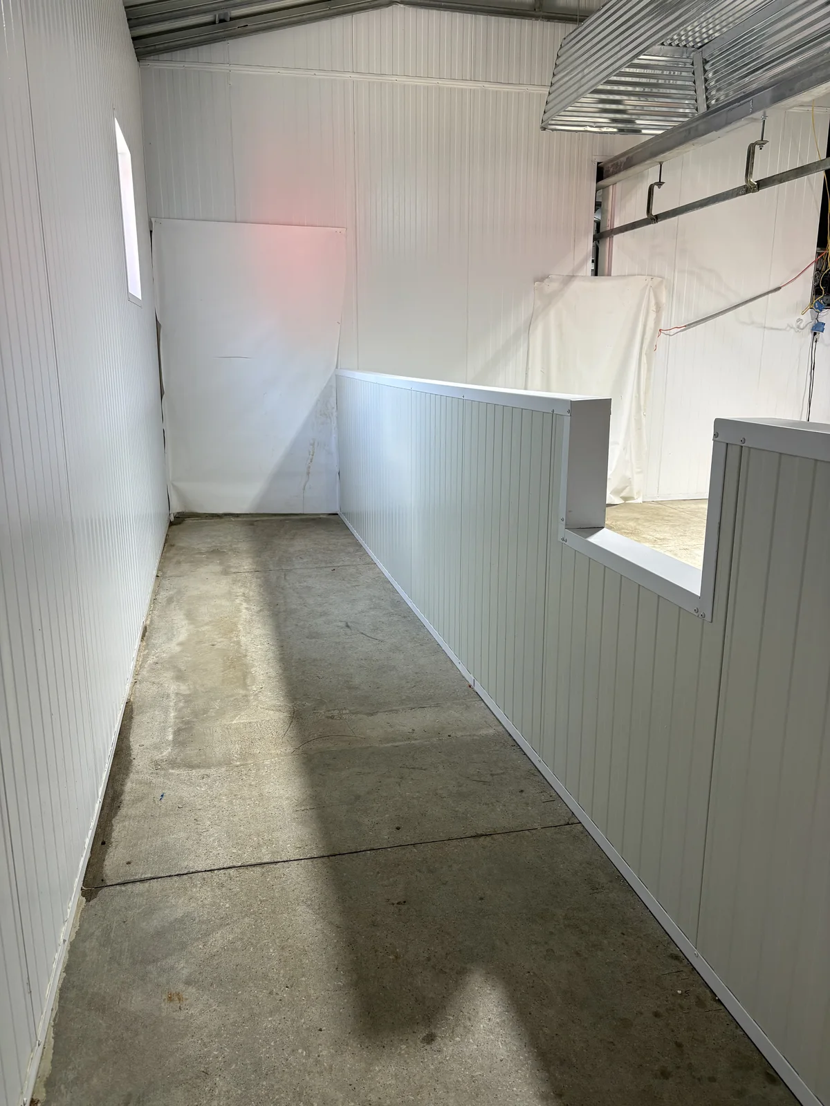 Same interior space with unfinished concrete floor before transformation