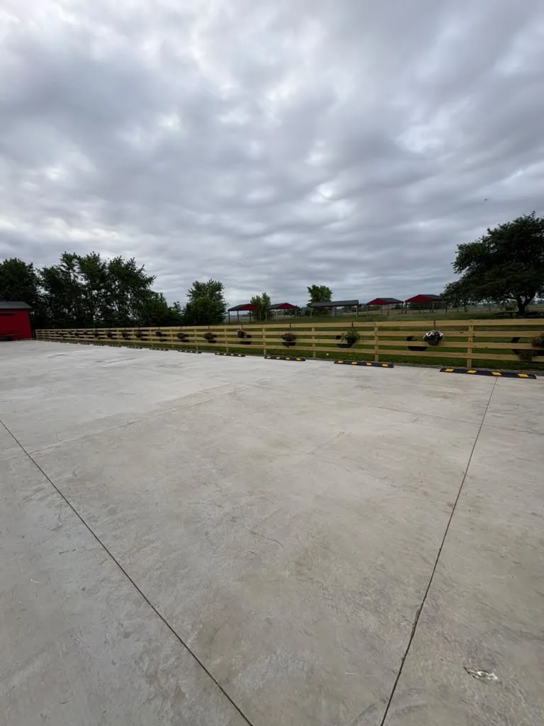 Completed concrete driveway and fenced property area